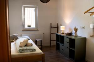 a small bedroom with a bed and a window at Anna's Landhaus in Soltau
