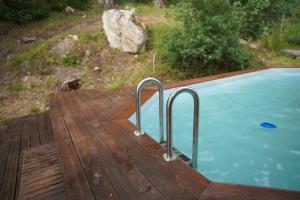 a pool on a wooden deck next to at Nuit au Ranch Horse Paradise & Jacuzzi in Boutigny-sur-Essonnes
