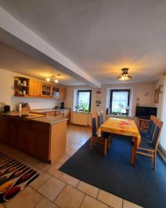 a kitchen and dining room with a table and chairs at Ferienhaus in Gera