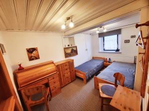 a bedroom with two beds and a desk and a chair at Ferienhaus in Gera