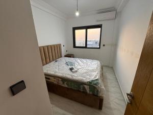 a small bedroom with a bed with a window at Al Hoceima - Vue sur la mer- Green Village Trougout in Al Hoceïma