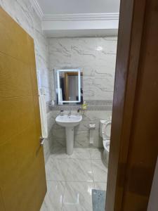 a bathroom with a sink and a toilet at Al Hoceima - Vue sur la mer- Green Village Trougout in Al Hoceïma +15 photos