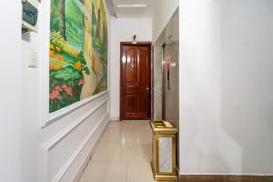 a hallway with a door and a painting on the wall at MÊ KÔNG HOTEL - Hotel H79 in Ho Chi Minh City