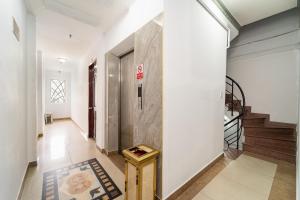a hallway with white walls and a stair case at MÊ KÔNG HOTEL - Hotel H79 in Ho Chi Minh City