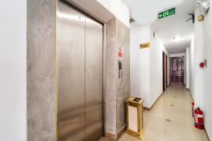 a hallway with a metal elevator in a building at MÊ KÔNG HOTEL - Hotel H79 in Ho Chi Minh City