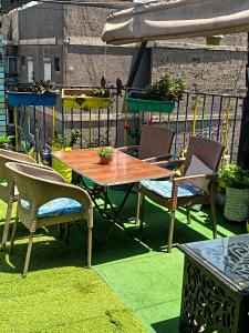 a wooden table and chairs on a patio at Castle hostel in Cairo