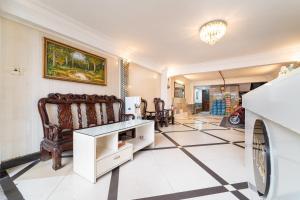 a living room with a table and a refrigerator at MÊ KÔNG HOTEL - Hotel H79 in Ho Chi Minh City +94 photos