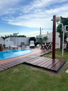 a backyard with a swimming pool and a wooden deck at Recanto Dos Lençóis in Barreirinhas
