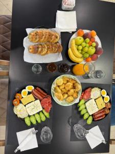 a table with different types of food on it at Gysi`s Hotel & Restaurant - Near Tirana in Tapizë