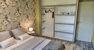 a bedroom with a bed and a large mirror at Samedi soir au calme in Val De Livre