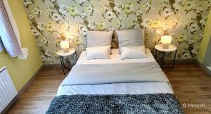 a bedroom with a bed with two tables at Samedi soir au calme in Val De Livre
