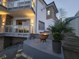 a house with a potted plant on a patio at Still in Struisbaai
