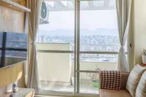 a living room with a large window with a view at Himalayan Heights Penthouse in Pātan
