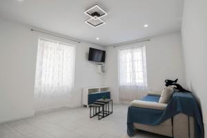 a living room with a couch and a tv at Apartma Svetlo udobje v Piranu - Bright Comfort Apartment in Piran in Piran