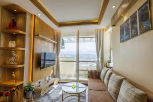 a living room with a couch and a table at Himalayan Heights Penthouse in Pātan
