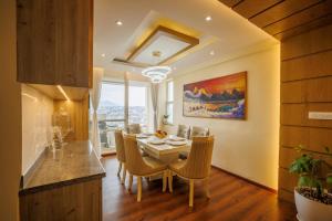 a kitchen and dining room with a table and chairs at Himalayan Heights Penthouse in Pātan