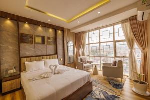 a bedroom with a large bed and a large window at Himalayan Heights Penthouse in Pātan +45 photos