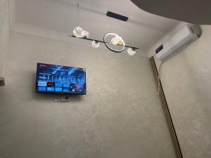a flat screen tv hanging on a wall at Rest hotel in Samarkand