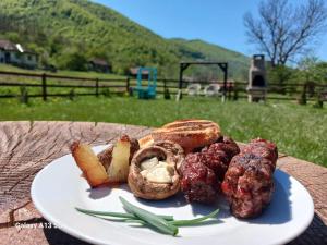 a plate of food on top of a table at Șura Moșului in Dobîca +29 photos