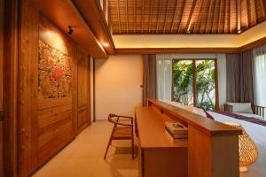a bedroom with a desk and a bed and a window at Apittoya Villas in Gianyar +31 photos