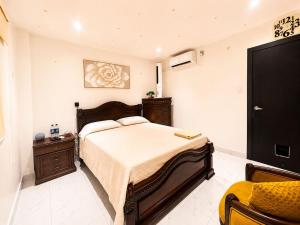 a bedroom with a large bed and a tv at Sweet Home in San Guillermo