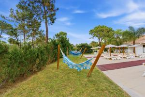 a hammock in the yard at a resort at Spot Troia - Boutique Suites in Troia +66 photos