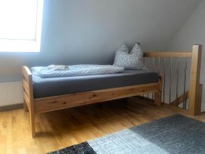 a bed in a room with a blue mattress at FeWo 02 Maisonette im Carre`Charlott in Pulsnitz