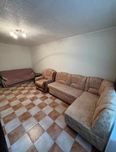 a living room with a couch and a checkered floor at Odesa Krasna, 8 Apart in Odesa