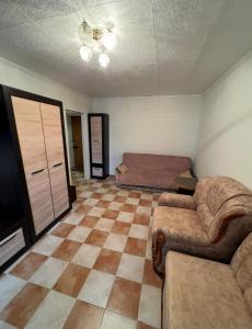 a living room with a couch and a bed at Odesa Krasna, 8 Apart in Odesa