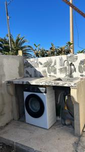 a washing machine with a table on top of it at La barraca del pescador in Denia