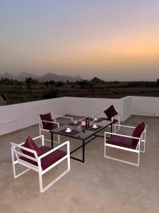 a group of chairs and a table on a patio at Jawai Mount Town in Mori Bera