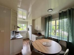 a kitchen with a wooden table and a dining room at Villa Lindäng Apartment -Vimmerby in Vimmerby