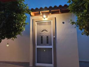 a door to a house with a light above it at Timeless Memories Studio in Zipárion