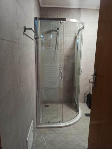 a shower with a glass door in a bathroom at Timeless Memories Studio in Zipárion +44 photos