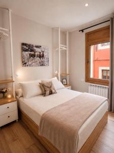 a bedroom with a large bed and a window at CaL QuEROL Select One in Puigcerdà