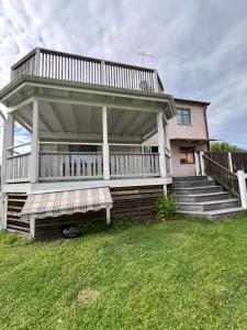 a house with a large deck on the front of it at Villa Lindäng Apartment -Vimmerby in Vimmerby