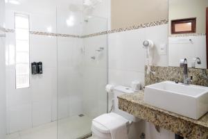 a bathroom with a shower and a sink and a toilet at Le Terrace in Morro de São Paulo