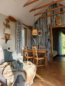 a living room with a couch and a table at Bosko beztrosko in Dębki