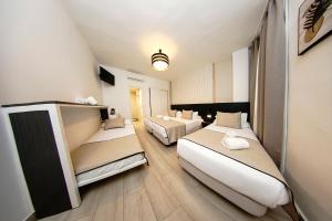 a hotel room with two beds in it at Hotel Zen Airport in Torremolinos +96 photos