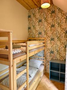 a room with three bunk beds in a cabin at Bosko beztrosko in Dębki