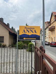 a sign that reads passion amina on a fence at Pension Anna in Löbau