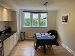 a kitchen with a table and a dining room at Ancluaran - Moat House 10 in Fort Augustus