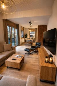a living room with a couch and a table at CaL QuEROL Select One in Puigcerdà