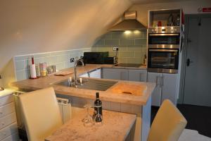 a kitchen with a sink and a counter top at Old Coach House Studio in Highley