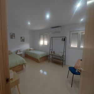 a bedroom with two beds and a mirror in it at Casa de angil in Tivenys +26 photos