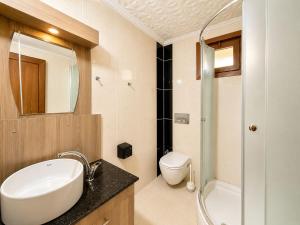a bathroom with a sink and a toilet and a shower at Şekersu Otel in Çaykara +31 photos