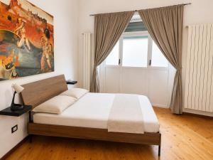 a bedroom with a bed and a painting on the wall at Milano Brenta Suites Room for 4 in Milan