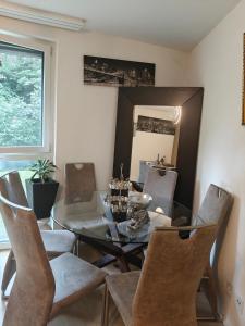 a dining room with a glass table and chairs at Home luna &zeus in Lausanne