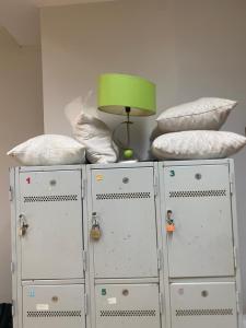 two white cabinets with pillows and a lamp on top at Hostel da Maria - Porto in Vila Nova de Gaia