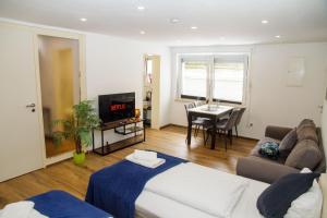 a living room with a bed a couch and a table at Apartment für 3, 2 Boxspringbetten, Internet & Parkplatz in Dortmund